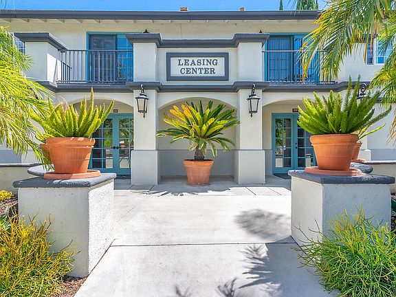 Exterior of entrance to leasing office surrounded by planters.