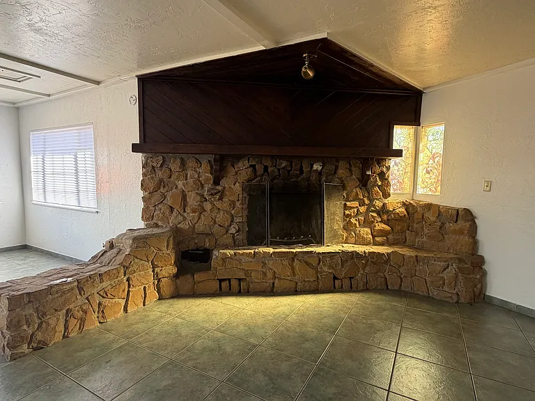 The entertainment room features a beautiful fireplace, creating the perfect setting for cozy evenings.