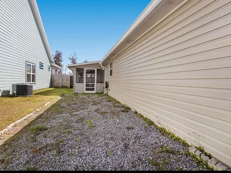 Gravel parking on left side of the house