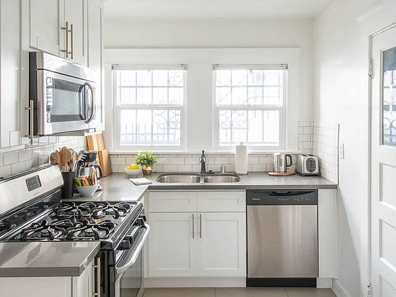 Full size kitchen with fridge, stove, microwave and dishwasher.
