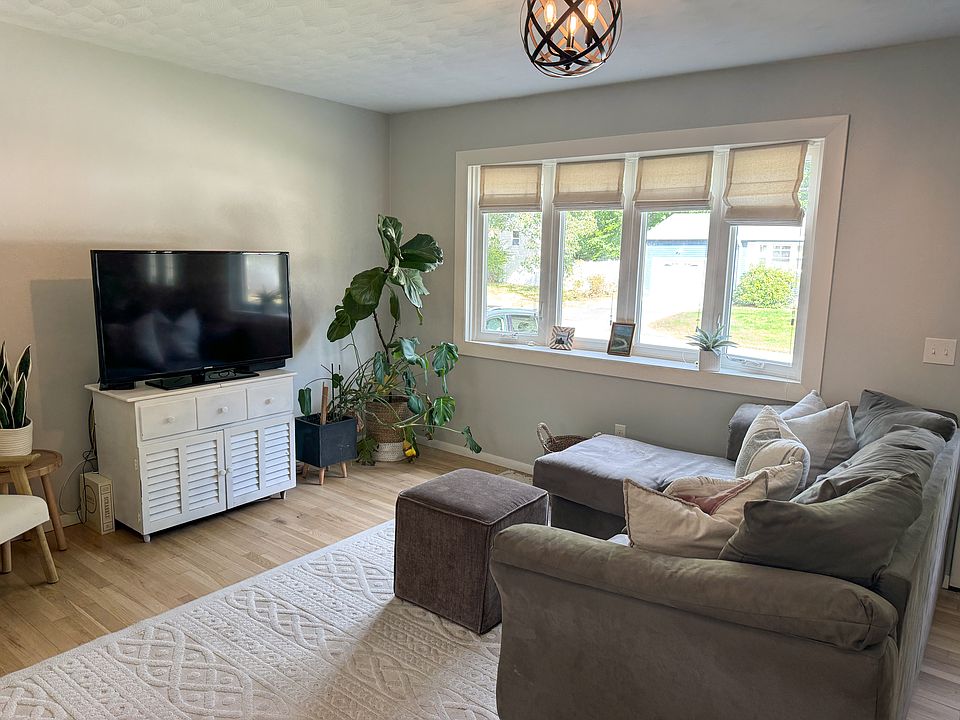 Open concept living room with bay window