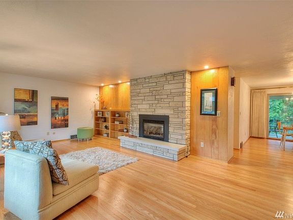 Open entry shows living and dining room and sliders to deck.  A coat closet is on the right.