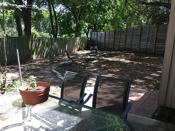 large backyard with paved patio off back door
