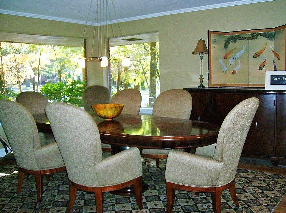 Very Large Formal Dining Room with Corner Picture Windows, Crown Molding, and Hardwood Floors.