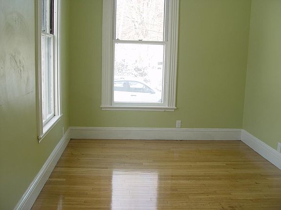 Living Room view from Front Door unfurnished. The walls are a Granny Smith apple green.