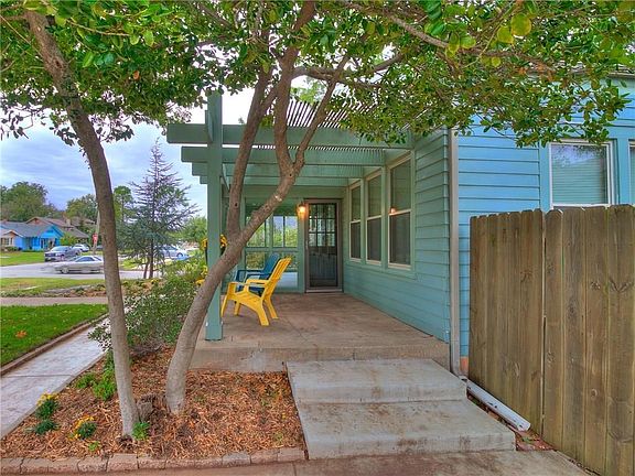 Front porch, wooden privacy fence, landscaping, corner lot