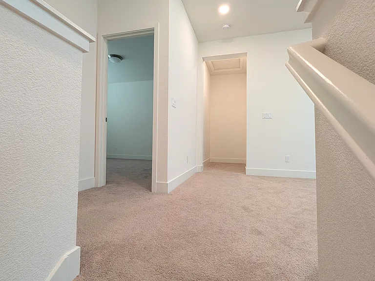 Upper Level Hallway
Designed for effortless flow, this bright hallway serves as the heart of the upper level. It seamlessly connects the expansive loft, grand master suite, and secondary bedrooms.