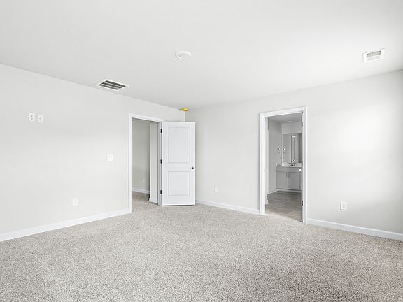 The primary suite leads to a well-appointed private bathroom.