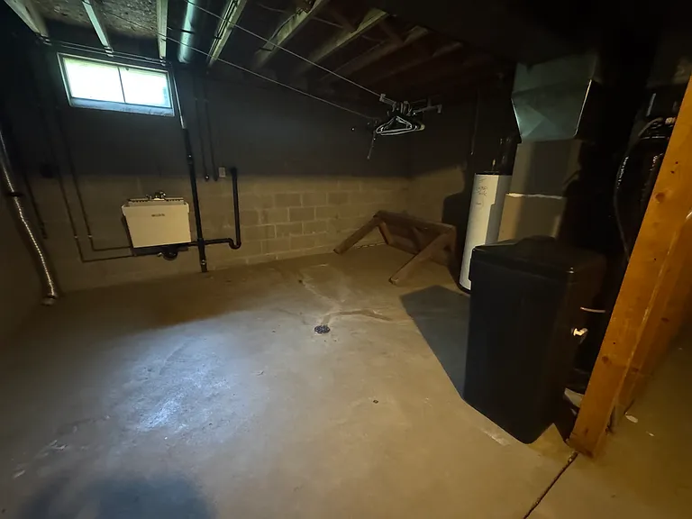 Unfinished basement (other side) with laundry hookups