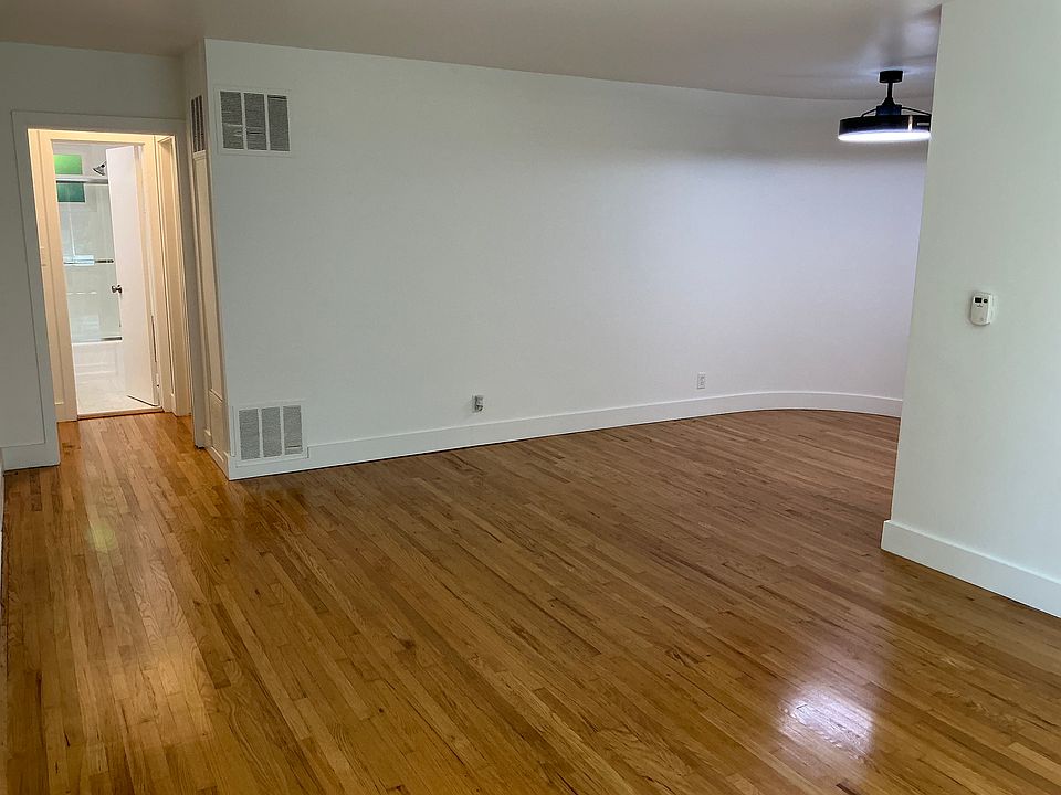 Spacious living and dinning area with real hardwood floors throughout in this retro/modern offering.