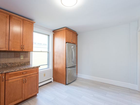 Kitchen featuring new flooring, full fridge/ freezer, oven/ stove, microwave and dishwasher.