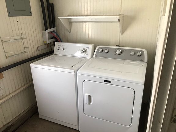 Washer and Dryer in laundry room at rear of garage