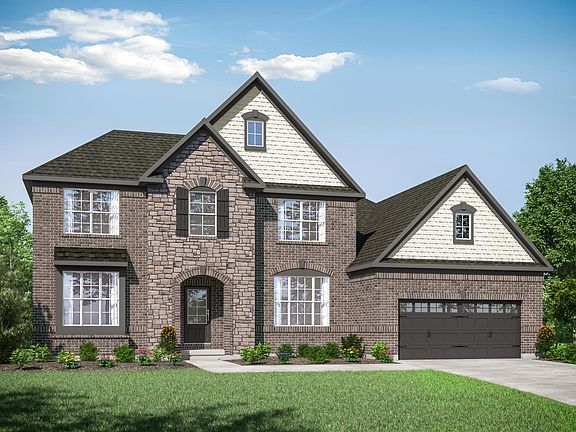 two-story home with brick, stone and shakes