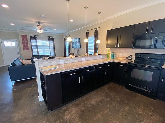 Kitchens featuring marble countertops and ample cabinetry.