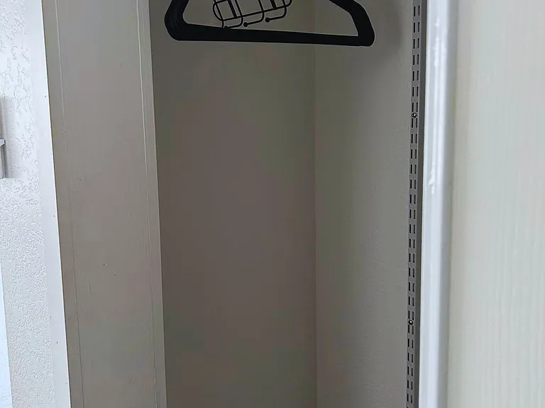 Closet space with hangers provided.