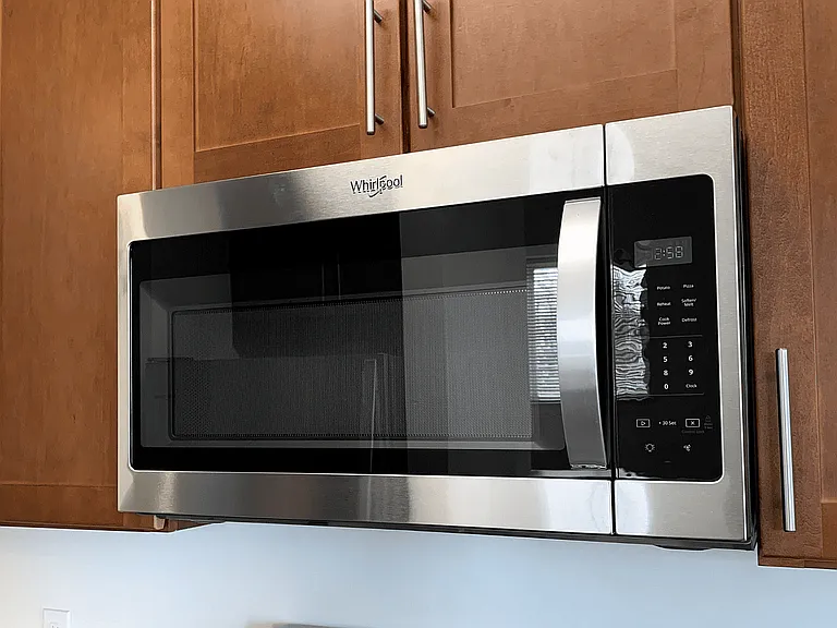 Gourmet-inspired kitchen featuring designer cabinetry, sleek granite countertops, and high-end stainless steel appliances.