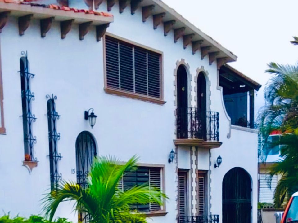 Bottom-floor 2BR/1BA with 2 office spaces, open entry/dining/living layout, large-screen TV, spacious laundry room with new washer/dryer, and garden marquesina patio with hammock + chairs. Five-minute walk to Isla Verde Beach and nearby coffee shops.