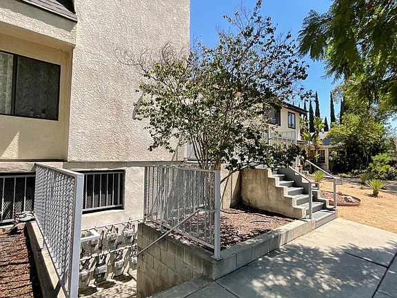 Staircase down to garage and staircase up to front gate
