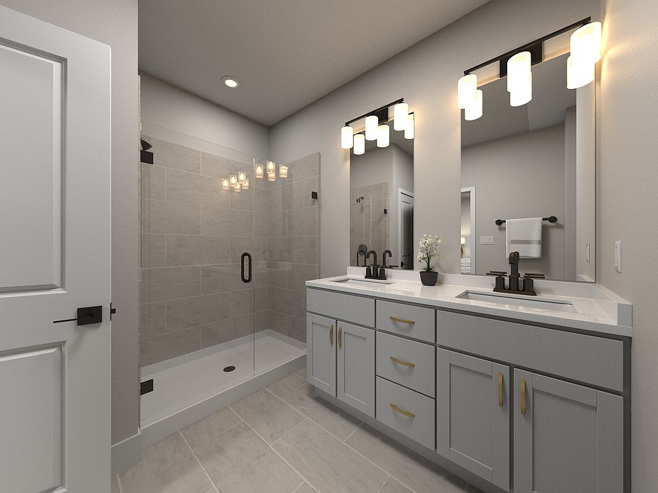 The primary bathroom offers dual vanity sinks and a walk-in closet.