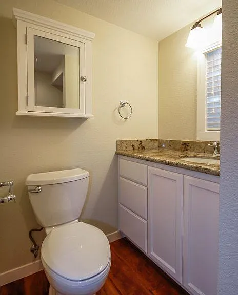 Downstairs half-bath with granite counter tops.