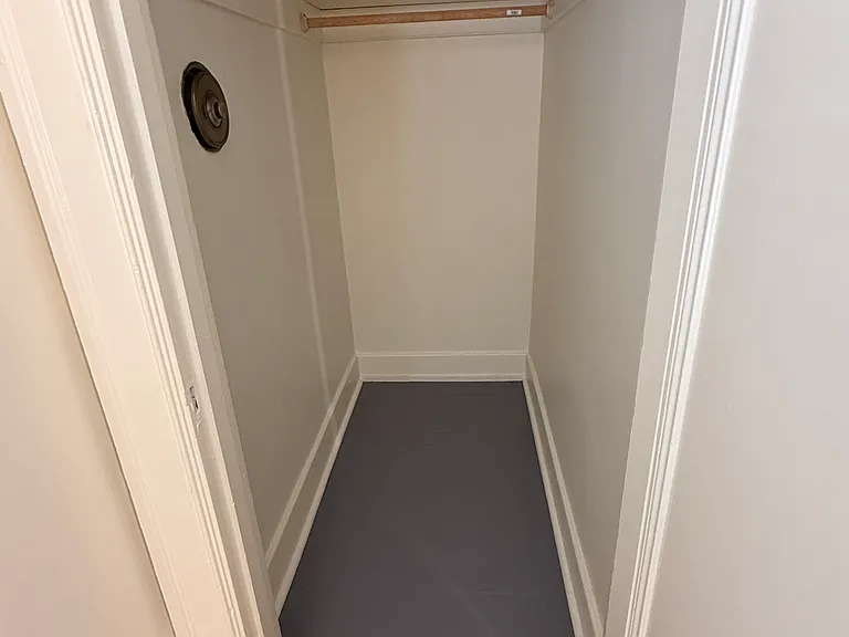 Bedroom walk in closet with wall safe