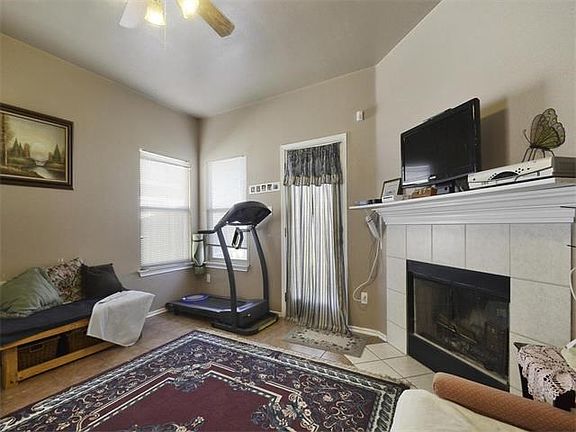 Living room with wood-burning fireplace.