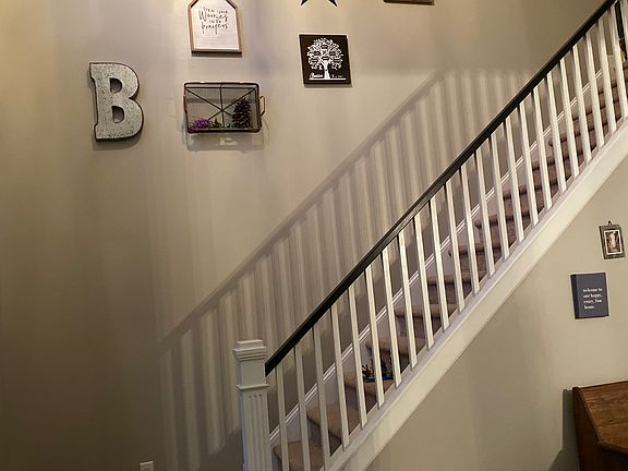 Staircase in vaulted foyer