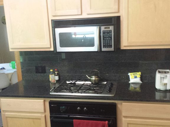 Updated kitchen, maple cabinets, stainless appliances, granite counters and back splash. tile & hardwood floors.