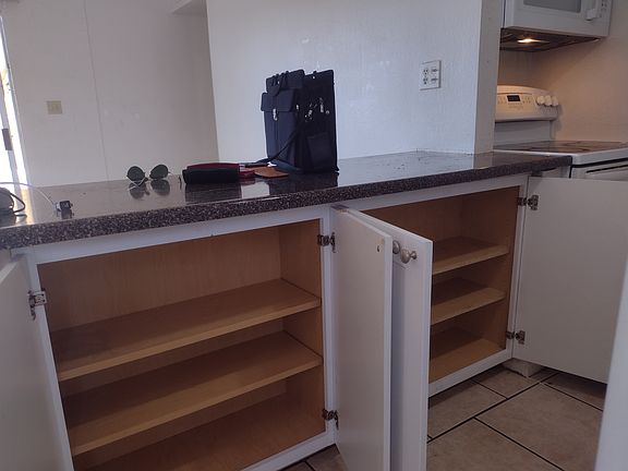 Kitchen counter and plenty of cabinetry...