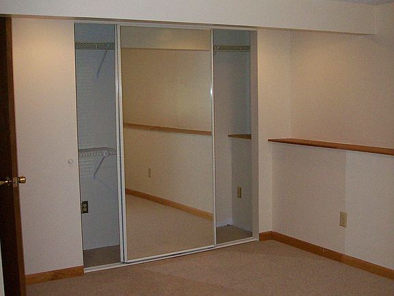 Lower level bedroom with mirror sliding closet doors