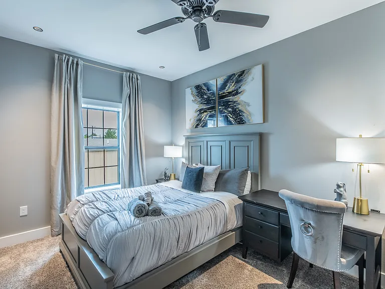 A peaceful bedroom with a dedicated workspace, perfect for remote work.