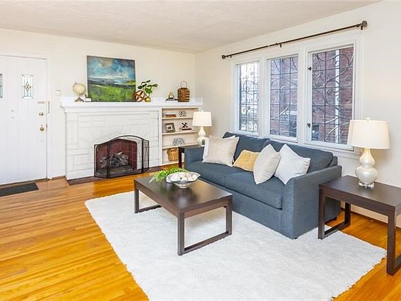 Gas fireplace enhances the ambiance of the living room.  Built in bookshelves for all your media.