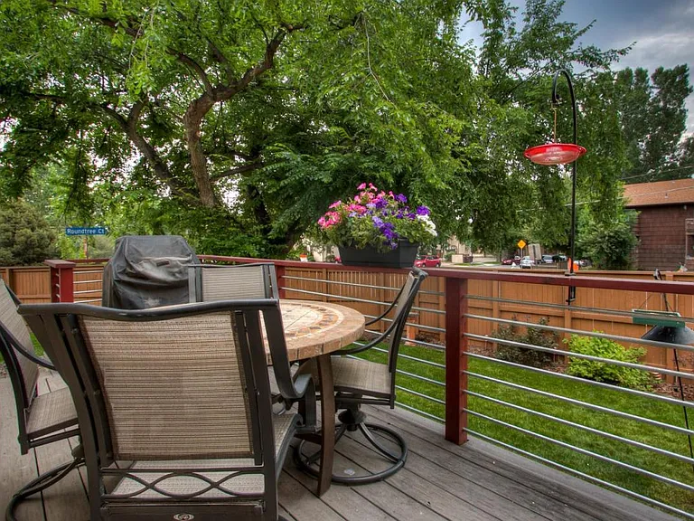 Beautiful backyard deck with bird friendly yard and garden