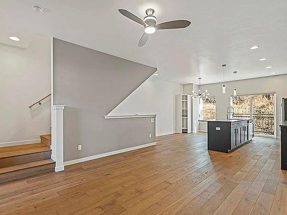Open-Concept Living - View from Living/TV Area. Small outdoor deck in the back.