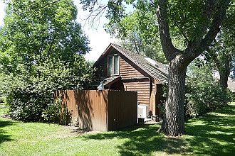 Landscaped grounds surround cottage.