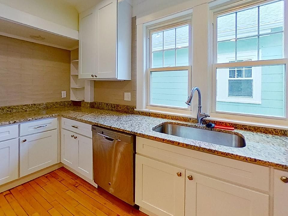 Kitchen with display area and tile backsplash.