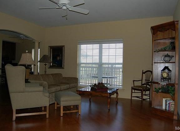 Great Room with ceiling fan, laminate flooring & side view of ca