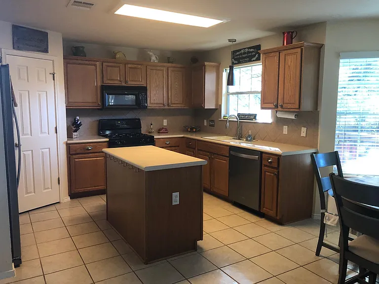Cabinets have been updated to white. Fridge is included in rental if desired.