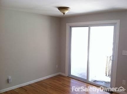 Dining area with hardwood floors, slider
