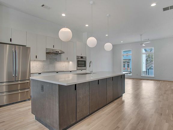 wide-open modern and bright kitchen and entertainment area