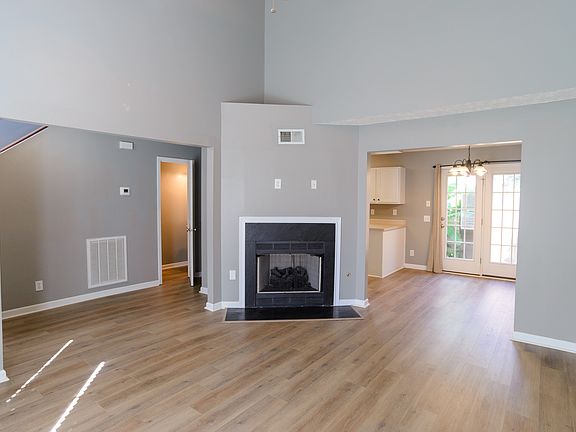 Beautiful, spacious open concept living room with vaulted ceilings, gas fireplace, new flooring and lots of light!