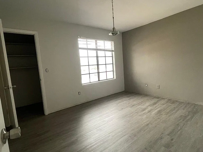 Bedroom 1 with walk-in closet. Luxury Viny floors throughout the unit except for the wet areas.
