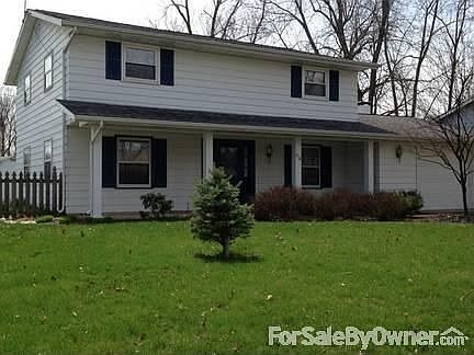 Large front yard with a entry way porch
