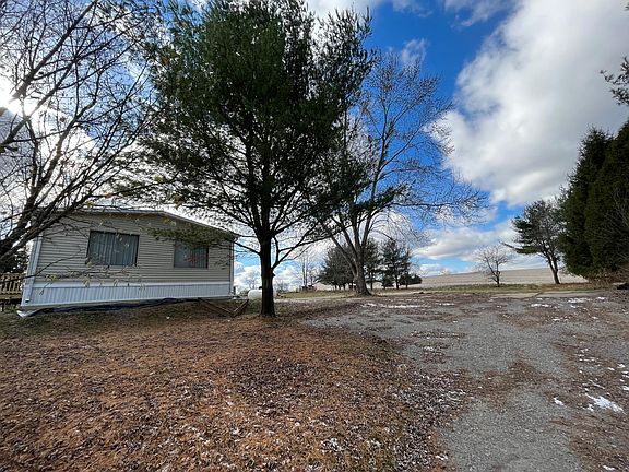 Side yard Parking area looking into back yard and neighbors field