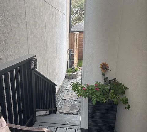 Front door entrance stairs to backyard with fountain view