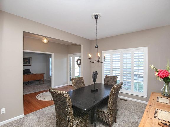 Spacious dining room has newer lighting & carpeting, freshly painted interior and plantation shutters.