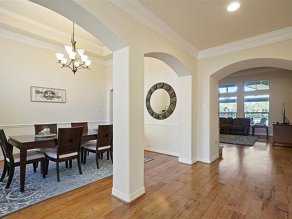 This spacious dining room is to the left as you enter the home. Gorgeous wood floors guide you in.