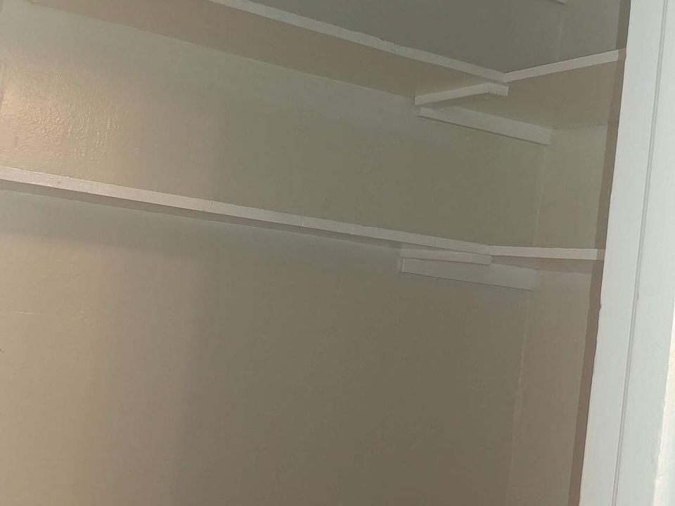 SHELVING ABOVE LARGE SHARED OFFICE (NOTE: OFFICE IS ENCLOSED AND HAS A WINDOW EXCELLENT SPACE FOR BUSY PROFESSIONALS TO WORK FROM HOME WHEN NEEDED. IT IS CURRENTLY STAGED WITH BEAUTIFUL CHERRY DESK AND HUTCH, OFFICE CHAIR PIC.S COMING SOON)