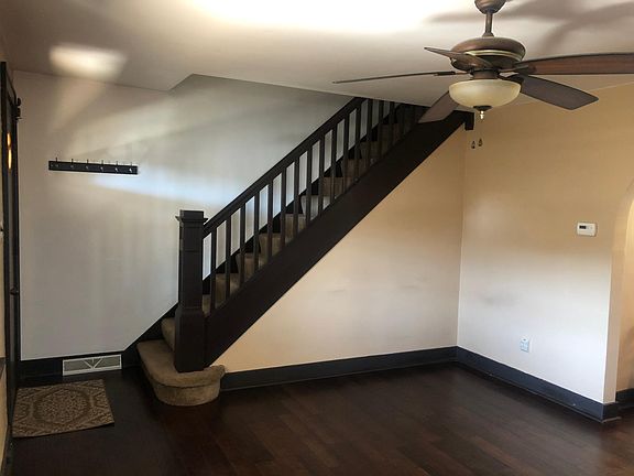 Other view of living room showing staircase to go upstairs.