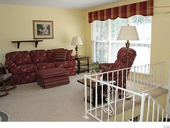 The living room is cozy and bright.  The three large windows add lot's of natural like.